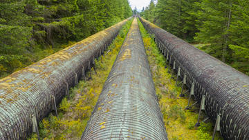 Image of a pipeline in Canada running through the middle of a forest.